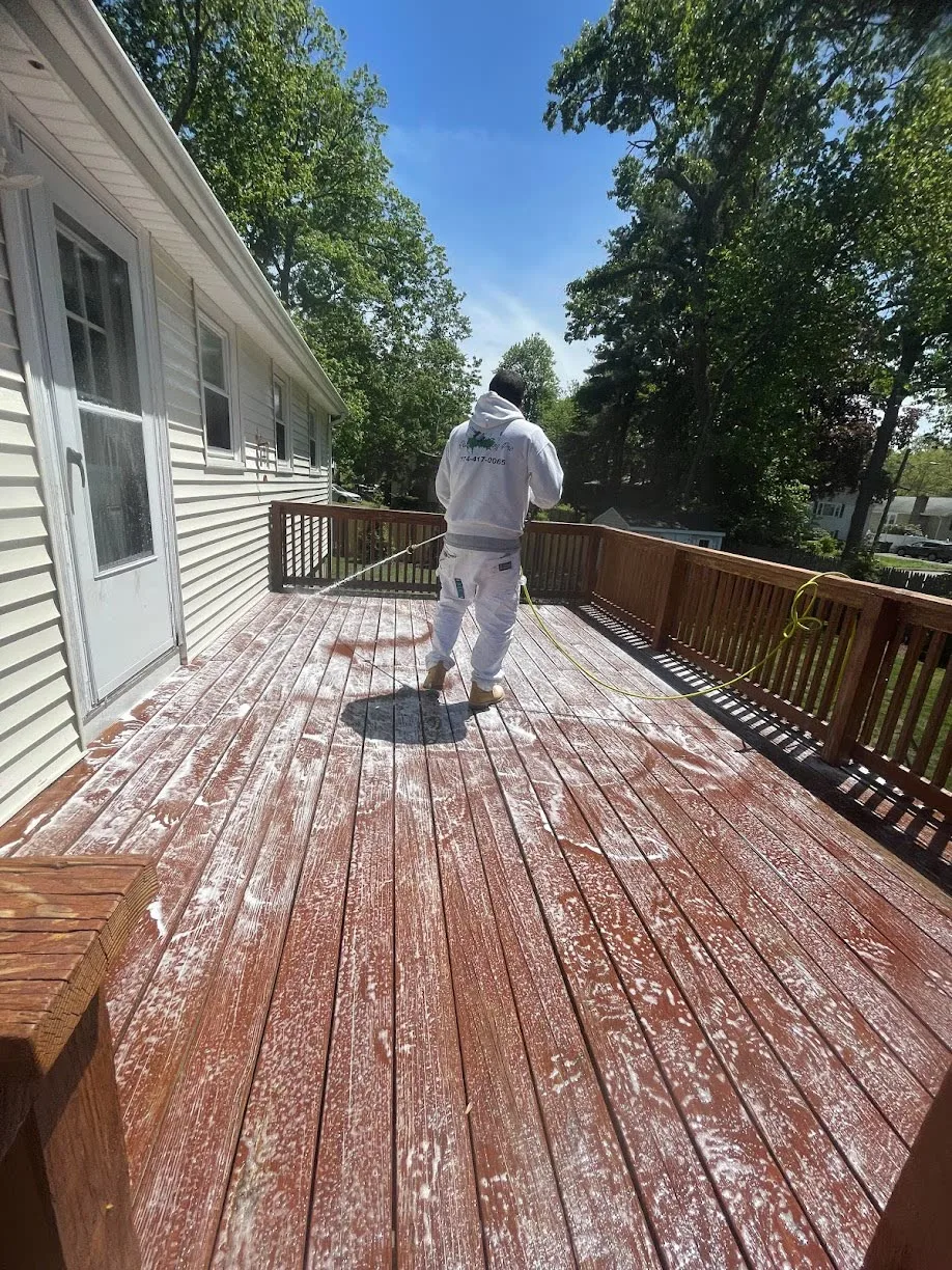 Professional deck pressure washing and surface cleaning before exterior painting
