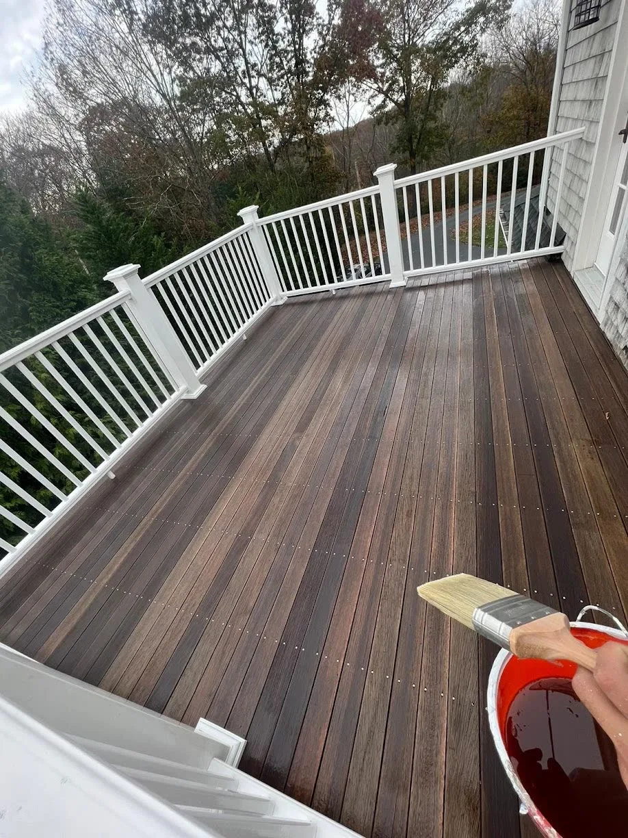 Restored mahogany deck with crisp white painted railings
