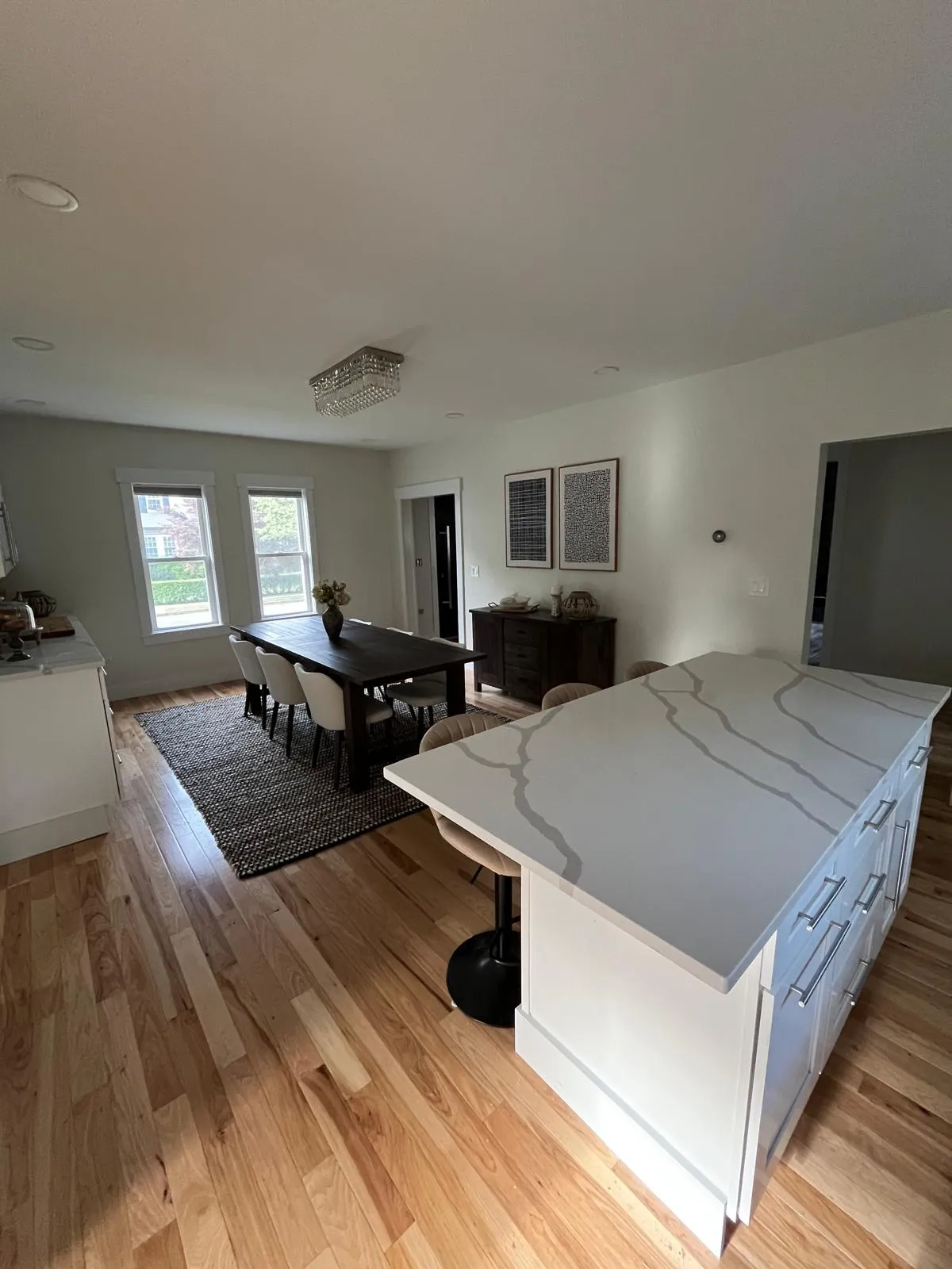 Open kitchen and dining area with white island interior painting in Weymouth MA